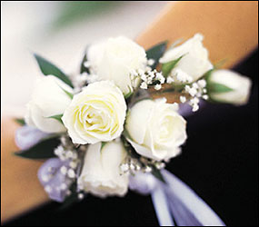 7 White Mini Roses Wristlet from Racanello Florist in Stamford, CT